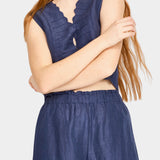 Front view of blueberry wide leg pants styled with brown vest and relaxed fit