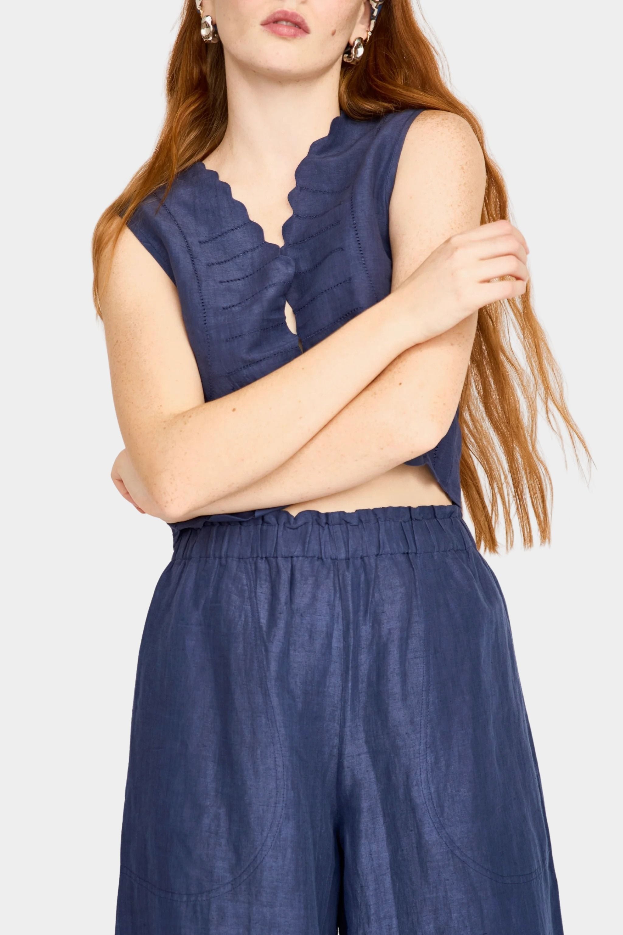 Front view of blueberry wide leg pants styled with brown vest and relaxed fit