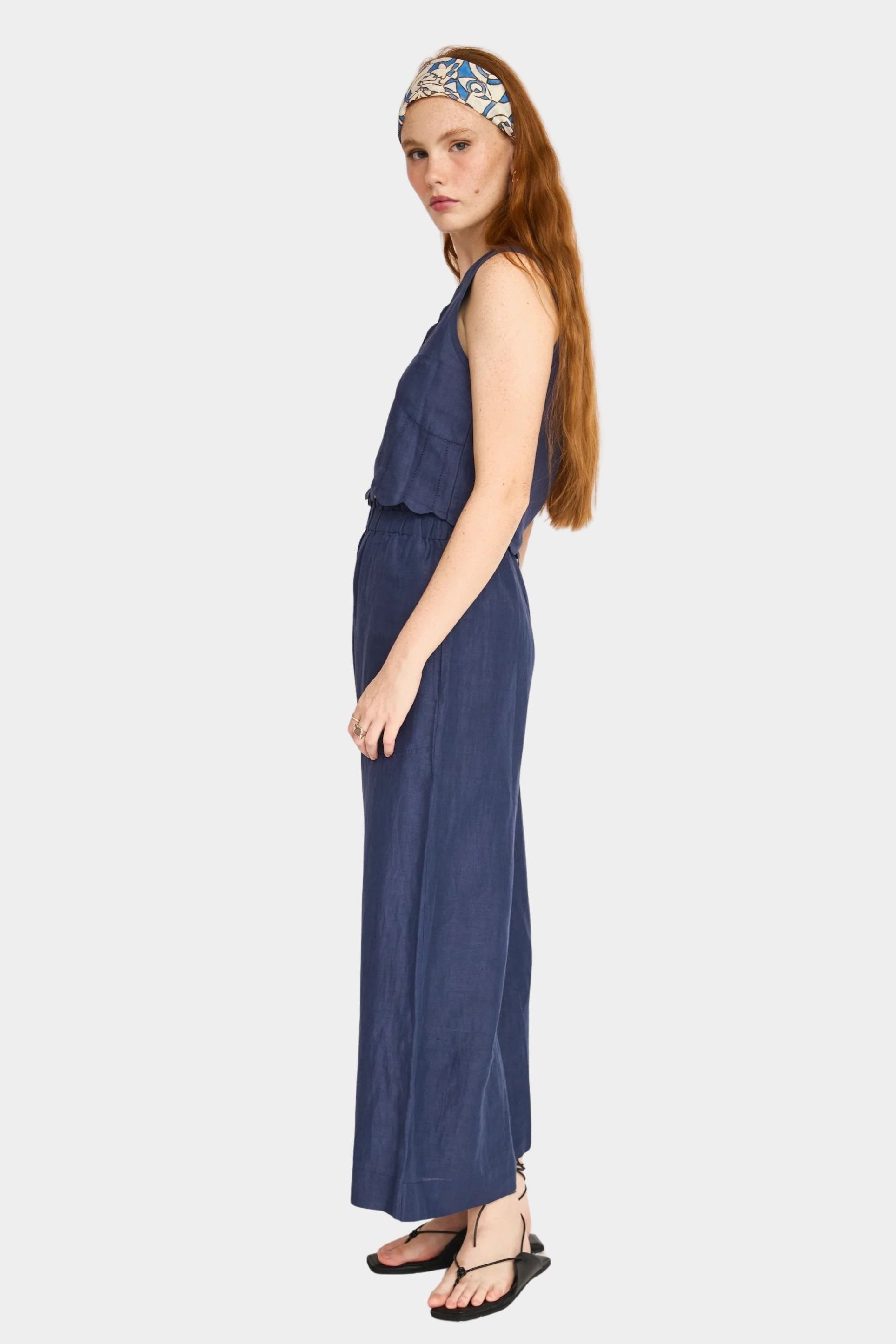 Side view of blueberry cotton pants with ankle length and wide leg drape