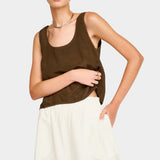 Close front view of white wide leg pants showing elastic waistband and relaxed fit through hips