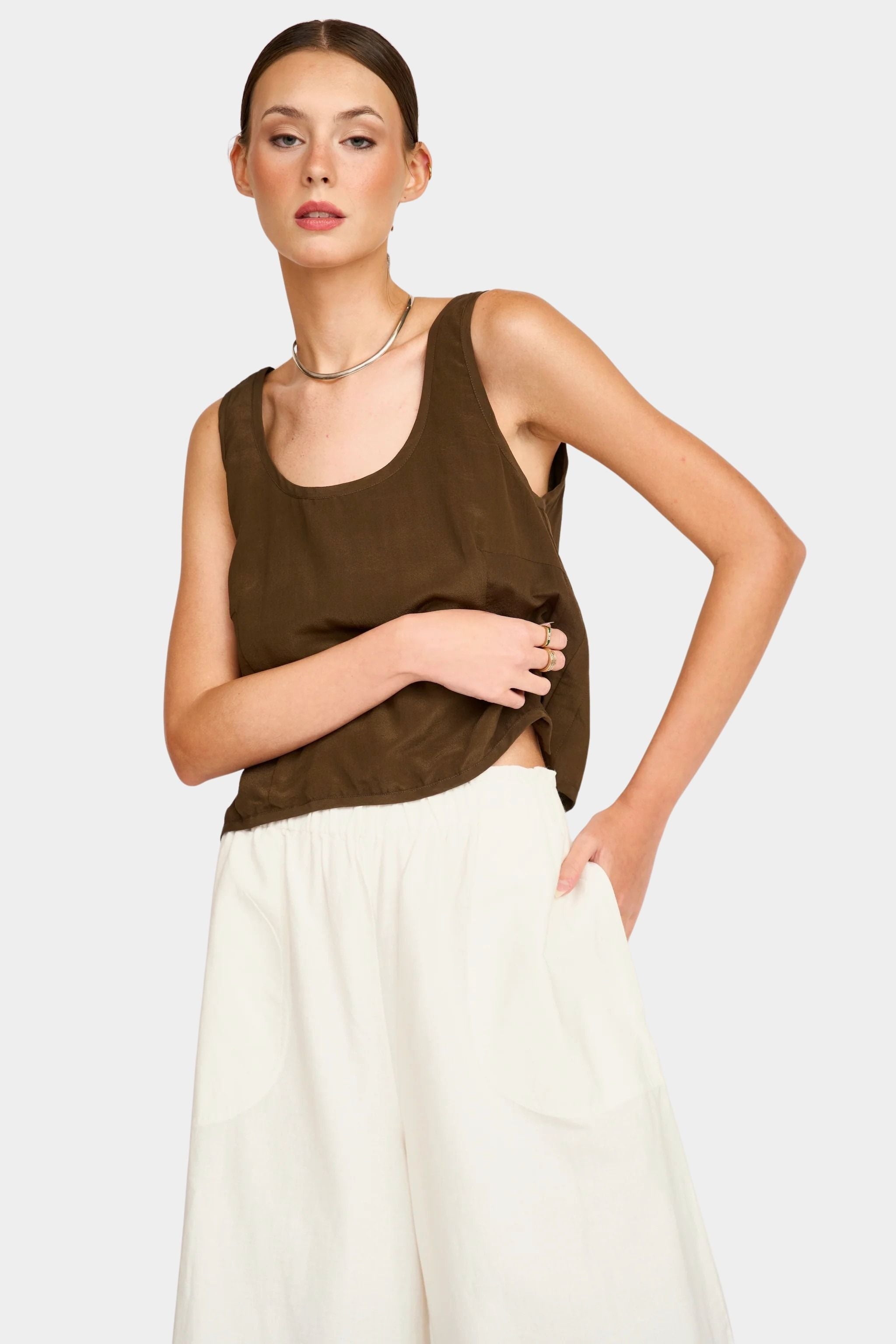 Close front view of white wide leg pants showing elastic waistband and relaxed fit through hips