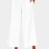 Front view of white cotton linen wide leg pants with elastic waistband and side pockets