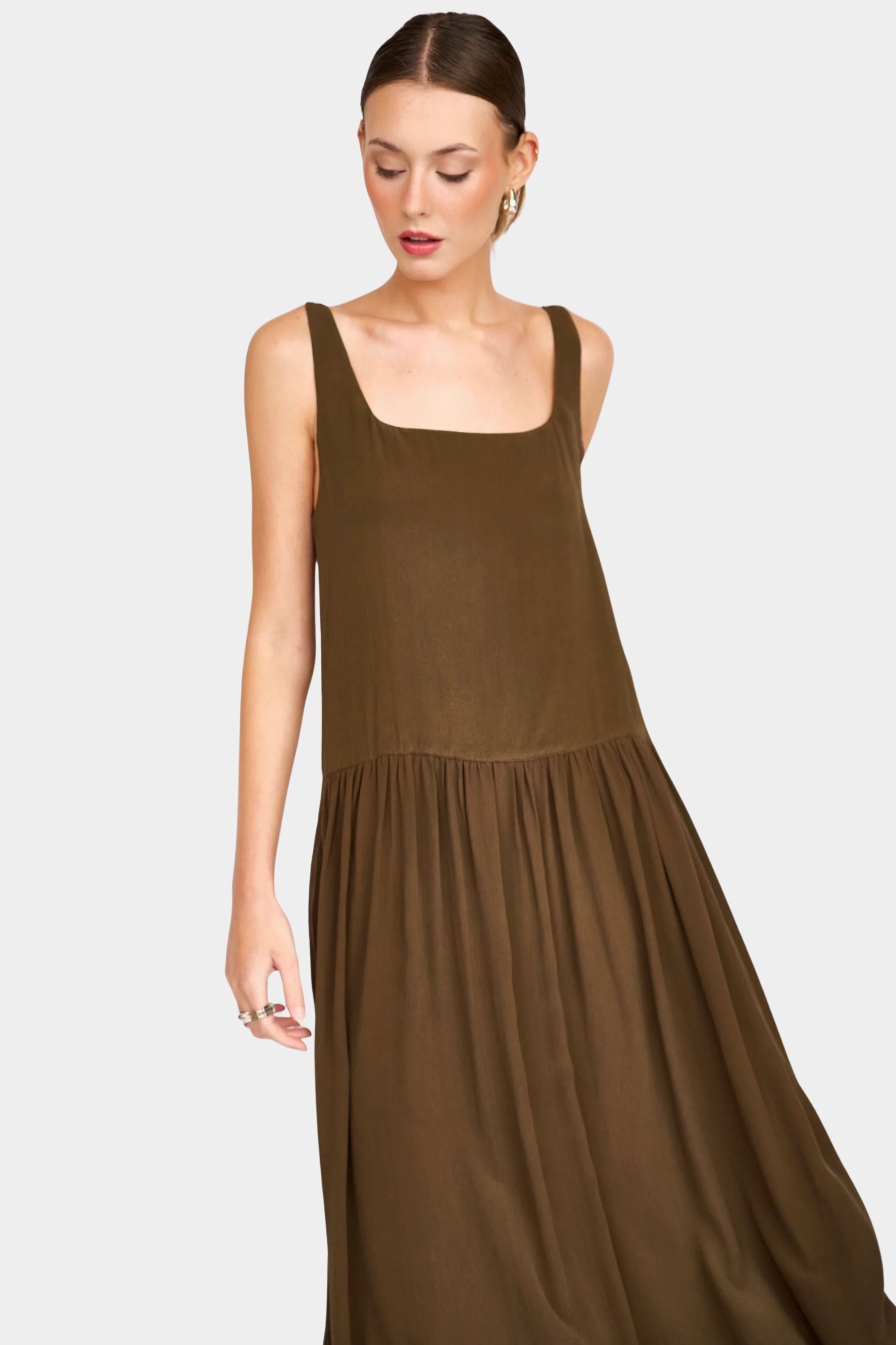 Front angled view of chocolate silk midi dress showing relaxed bodice and gathered skirt