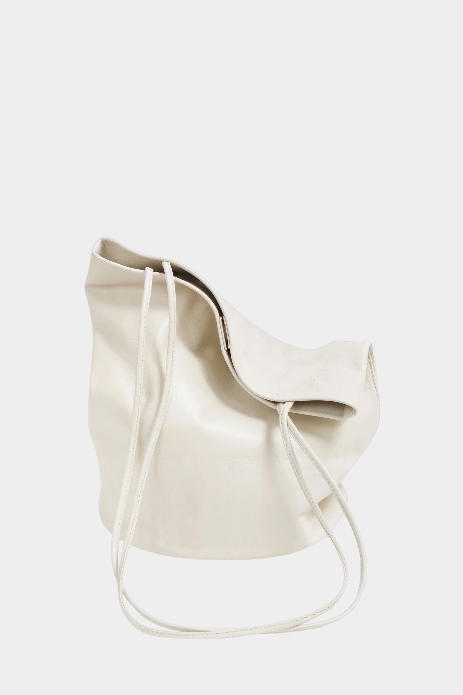 Soft Creme leather Drape Oval Bucket folded to show its drape and slender straps