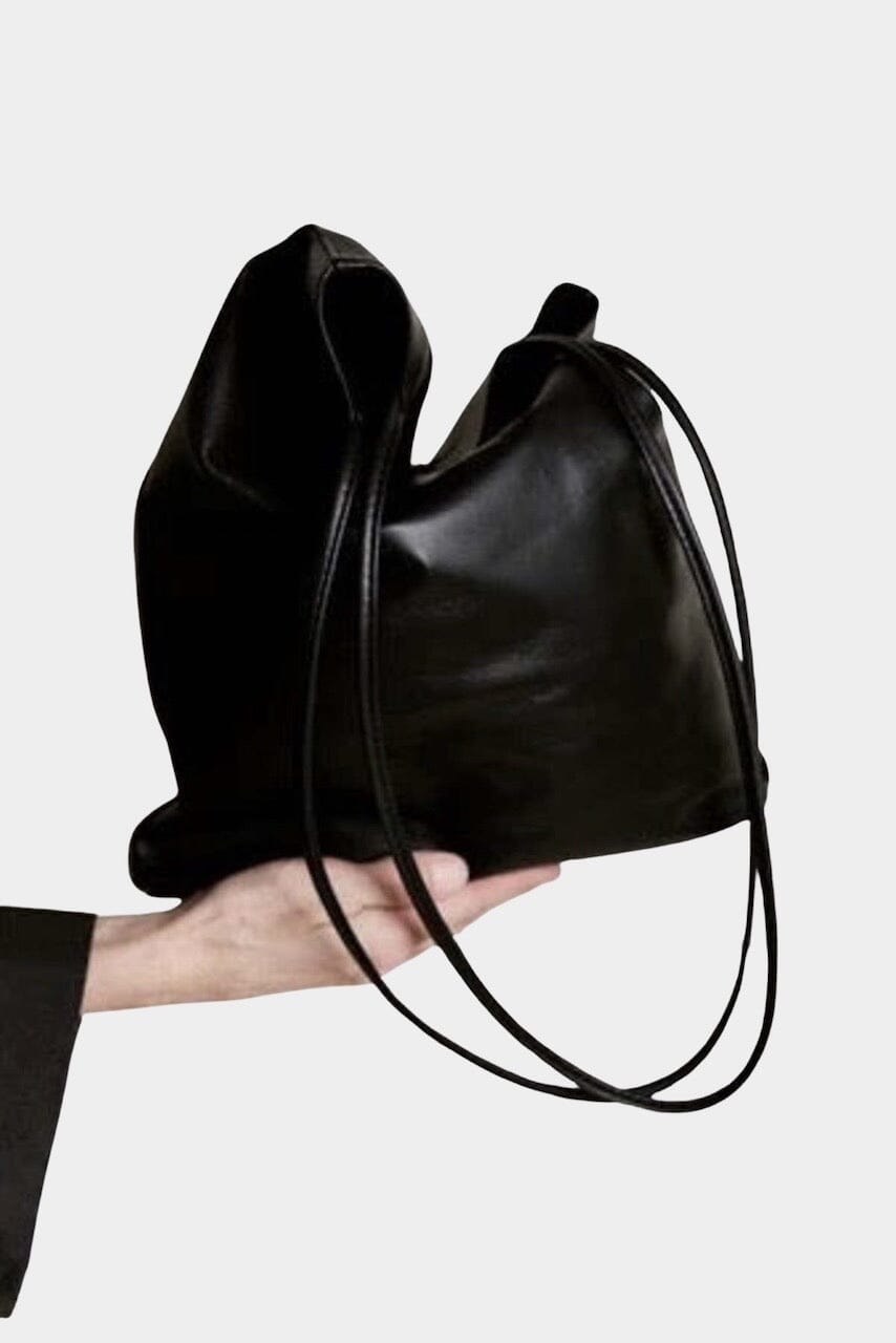 Modern Weaving Slim Elongated Tote Black worn on shoulder showing tall vertical silhouette and slim straps