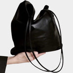 Modern Weaving Slim Elongated Tote Black worn on shoulder showing tall vertical silhouette and slim straps