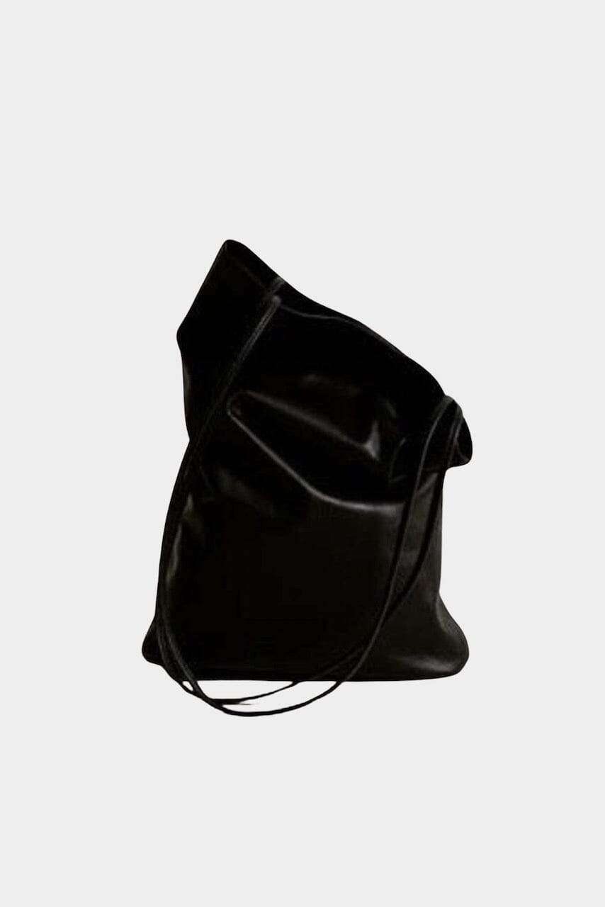 Modern Weaving Slim Elongated Tote Black held by hand highlighting narrow shape and fluid leather drape