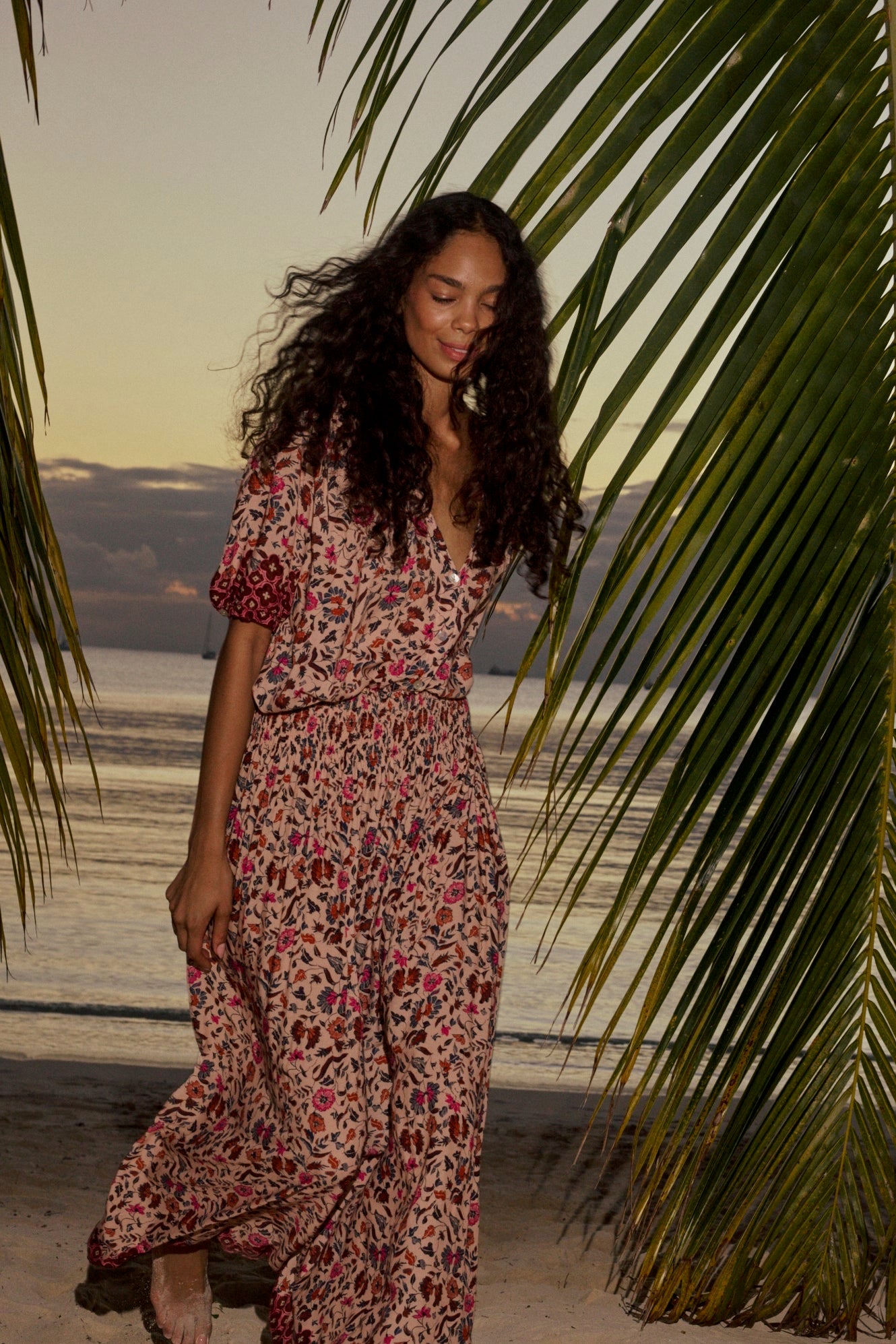 Natalie Martin Bella Skirt Wildflower Spice lifestyle image with floral maxi skirt and soft drape at the beach