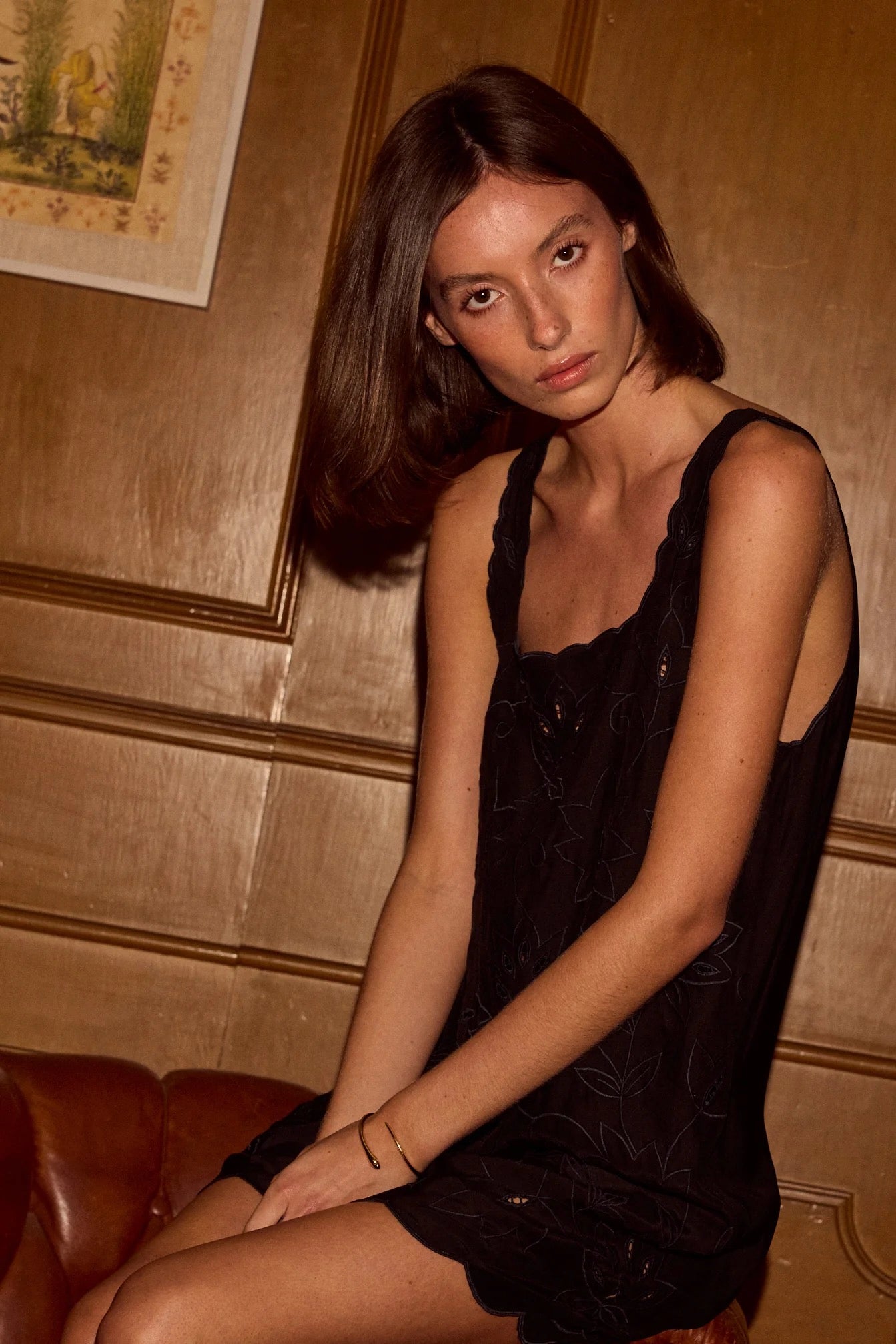 Natalie Martin Nadia Dress Black Silk Embroidery seated portrait with fluid black silk and tonal embroidery detail