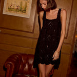 Natalie Martin Nadia Dress Black Silk Embroidery editorial standing view with soft silk movement and mini length silhouette