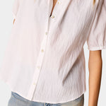 Detail view of Natalie Martin Violet Top in White Flat Cotton showing lightweight crinkled cotton texture and shell button front