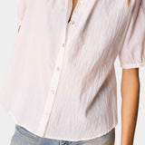 Detail view of Natalie Martin Violet Top in White Flat Cotton showing lightweight crinkled cotton texture and shell button front