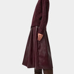 No.6 Mel Skirt in Bordeaux, full side view with a knit sweater and boots