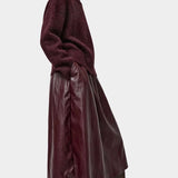 No.6 Mel Skirt in Bordeaux, side view styled with a burgundy sweater and tall boots