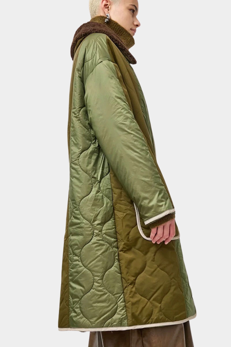 No.6 Summit Jacket in Olive, angled side view showing the two olive tones and quilted texture