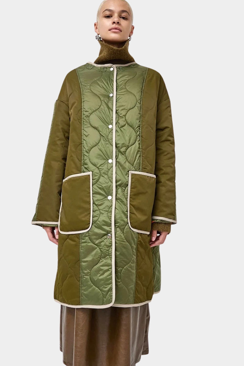 No.6 Summit Jacket in Olive, front view showing the quilted coat over a turtleneck
