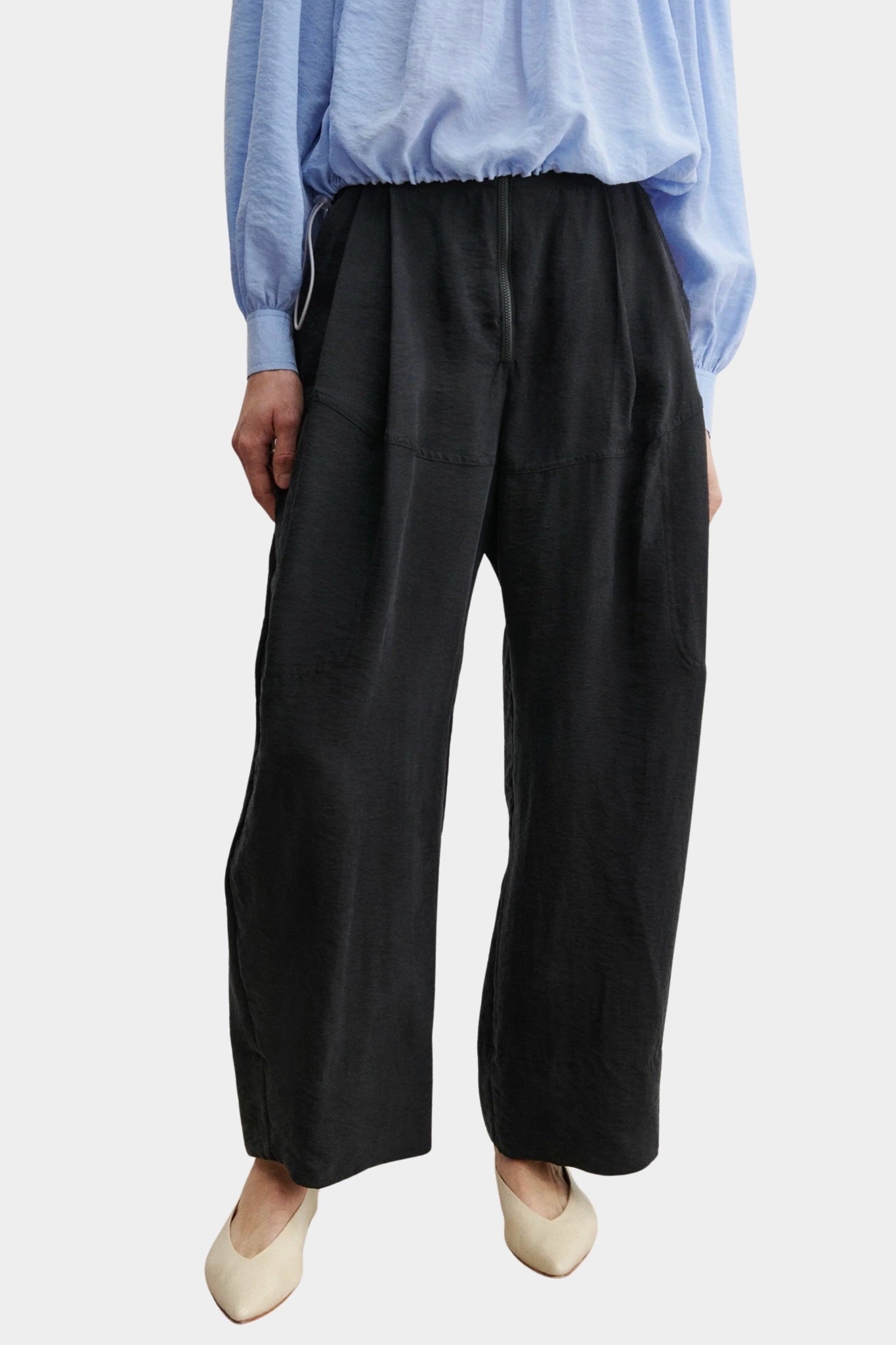 Rachel Comey Dini pant in black with high waist, wide-leg silhouette, and soft front pleating, styled with blue blouse