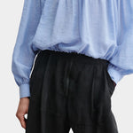 Rachel Comey Dini pant in black, close-up highlighting elastic waistband, pleating, and lightweight texture