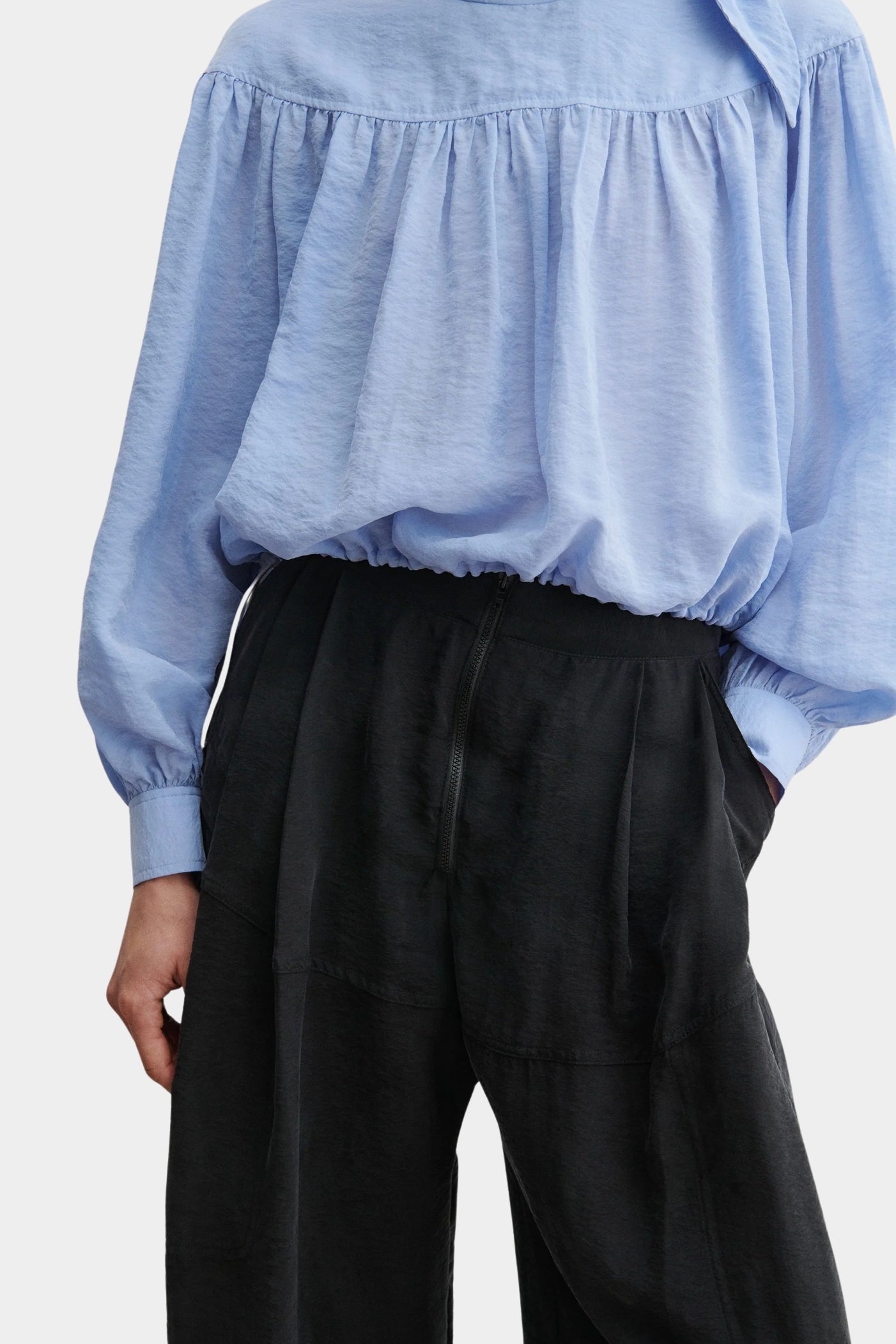 Rachel Comey Dini pant in black, close-up highlighting elastic waistband, pleating, and lightweight texture