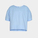Rachel Comey rugby top in light blue cotton, flat lay showing clean neckline, soft structure, and cropped silhouette