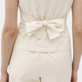 Rita Row Holan top in beige sleeveless top with back bow tie detail and matching pants rear view