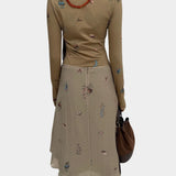 Rodebjer Kiara Henley top in beige multi duchess floral print, back view showing slim fit and long sleeves styled with coordinating skirt