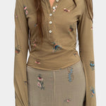 Rodebjer Kiara Henley top in beige multi duchess floral print, fitted long sleeve henley with button placket front view styled with matching skirt