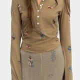 Rodebjer Kiara Henley top in beige multi duchess floral print, fitted long sleeve henley with button placket front view styled with matching skirt