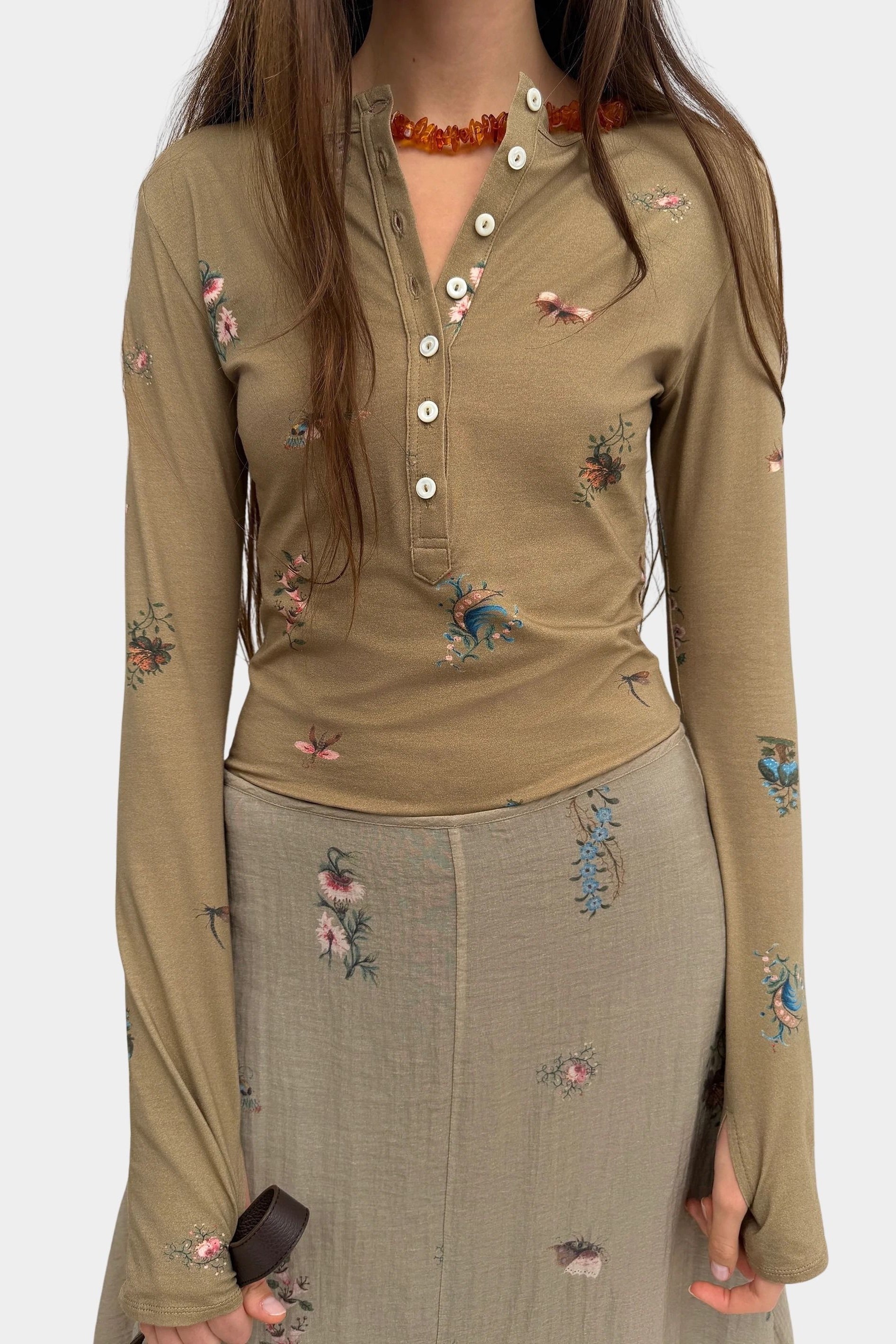 Rodebjer Kiara Henley top in beige multi duchess floral print, fitted long sleeve henley with button placket front view styled with matching skirt