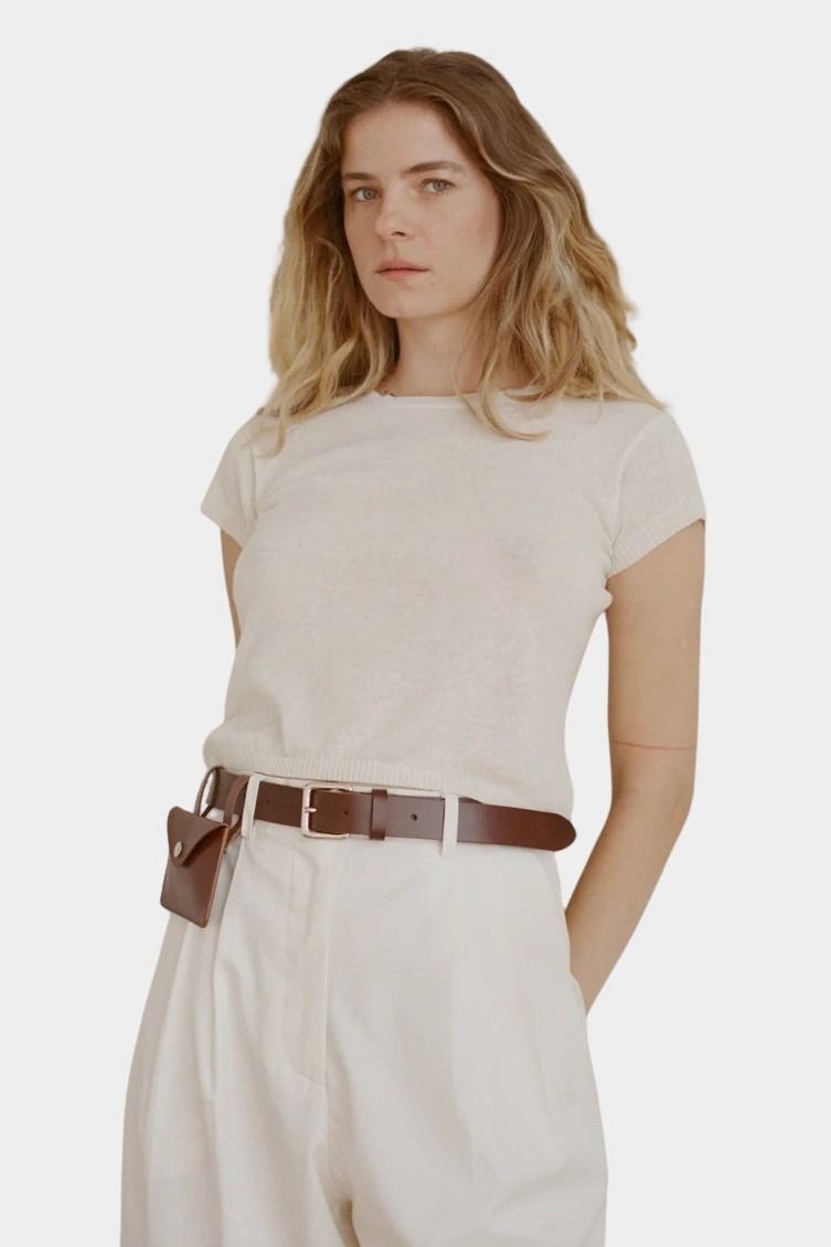 Shaina Mote Baby Tee Chalk soft knit tee styled with high-waisted ivory pants and cognac belt with pouch