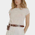 Shaina Mote Baby Tee Chalk soft knit tee styled with high-waisted ivory pants and cognac belt with pouch
