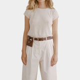 Shaina Mote Baby Tee Chalk full look fitted cream tee with relaxed ivory trousers and brown belt styling