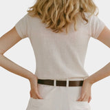 Shaina Mote Baby Tee Chalk back view fitted short sleeve knit tee styled with ivory trousers and leather belt