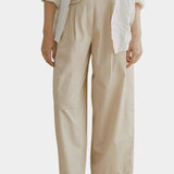 Shaina Mote Summer Chino Beige front view pleated high rise wide leg cotton pant with sandals