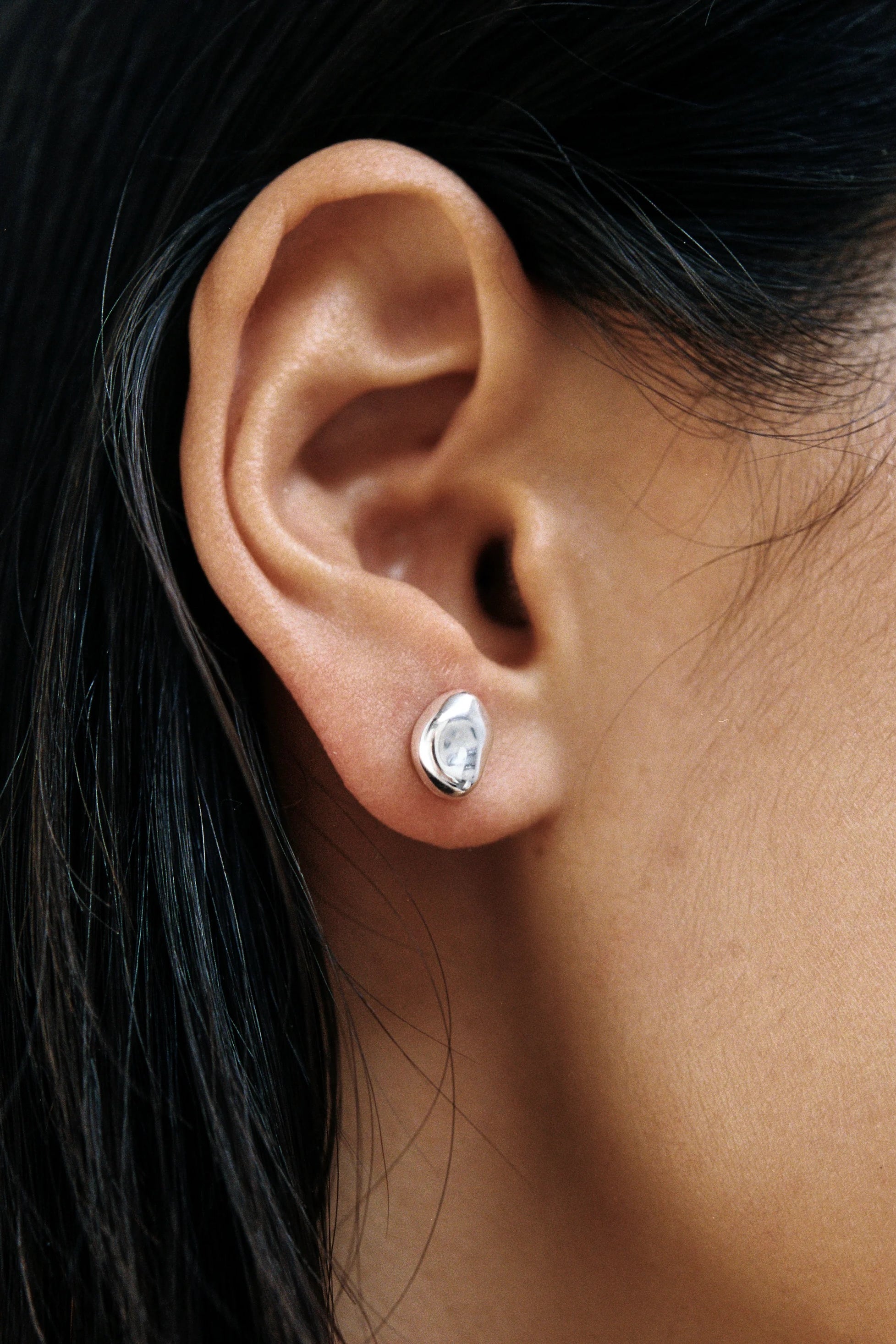 Bean Stud Earrings Sterling Silver Wolf Circus worn on ear close up sculptural silver stud earrings