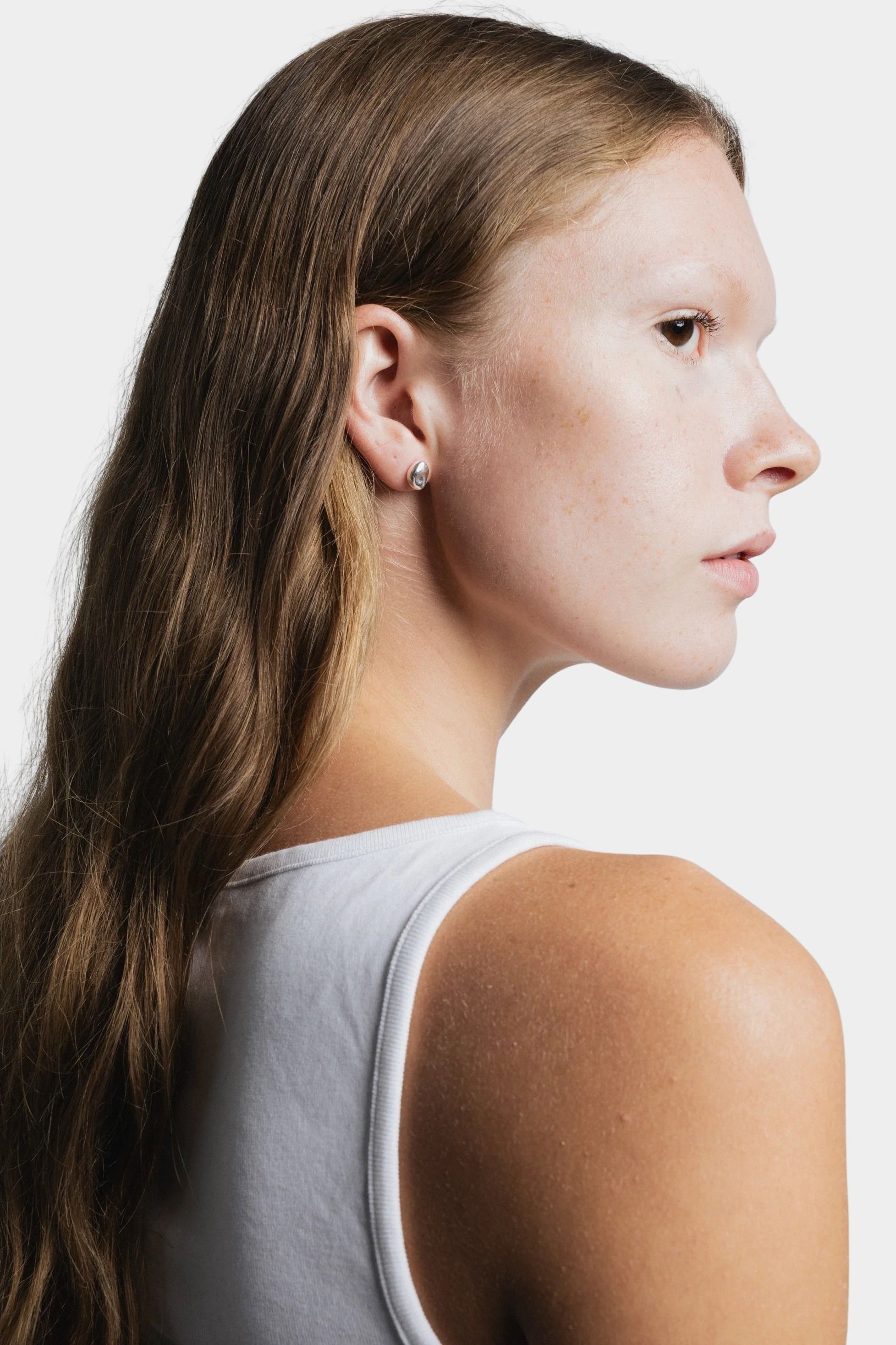 Bean Stud Earrings Sterling Silver Wolf Circus side profile worn minimal silver stud earrings