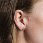 Bean Stud Earrings Sterling Silver Wolf Circus worn close up on ear polished silver stud earrings