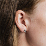 Bean Stud Earrings Sterling Silver Wolf Circus worn close up on ear polished silver stud earrings
