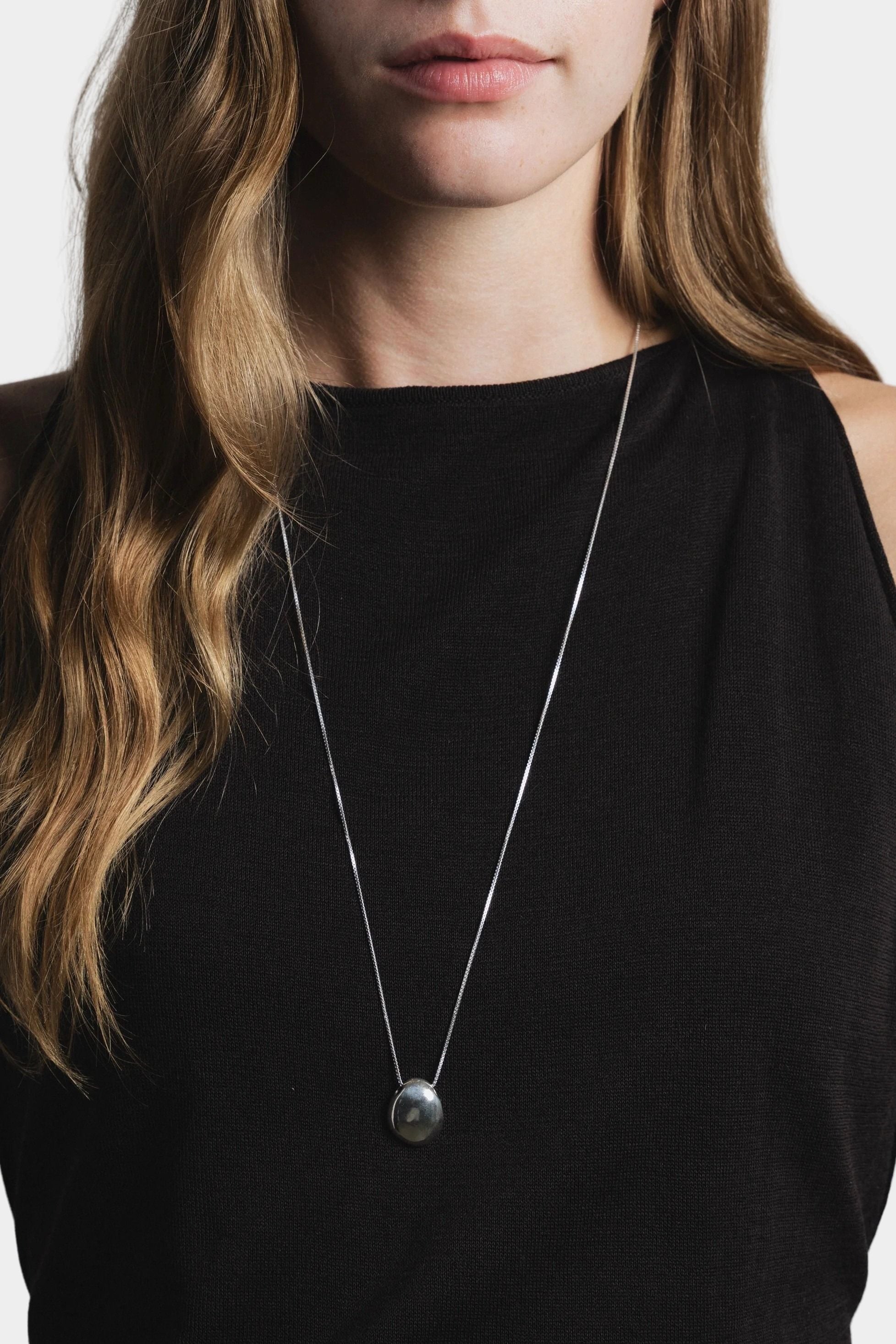 Wolf Circus Naya necklace sterling silver pendant detail worn on black top