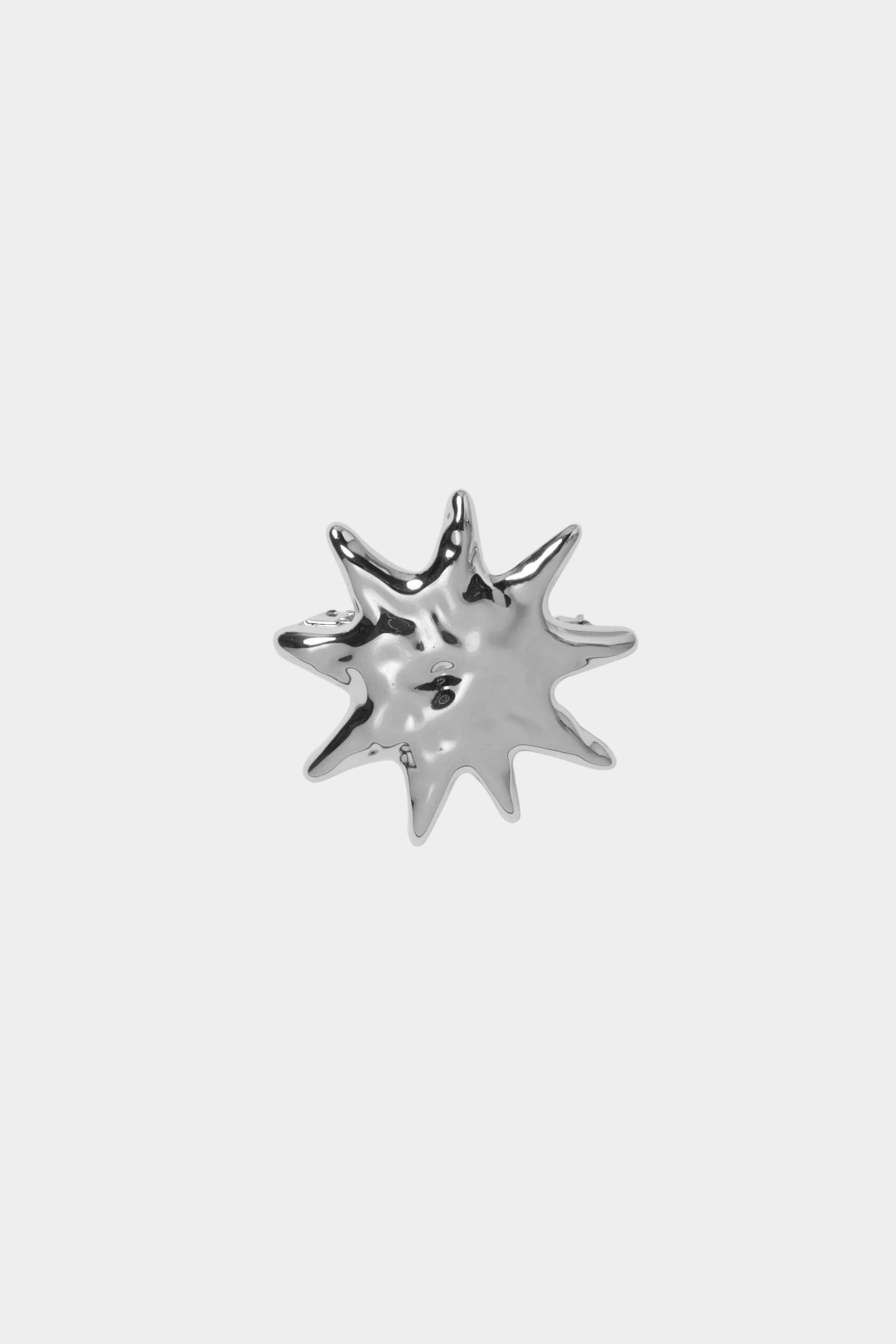 Flat lay silver sculptural sun hair clip high polish finish