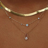 Opal and diamond linear chain necklace layered with delicate gemstone jewelry